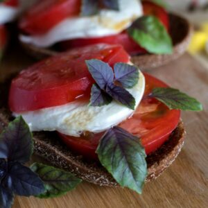 A close up of a sandwich on a wooden board